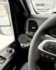 Tactic Engineering MagSafe phone mount installed on Iveco Daily dashboard, wider angle view showing mount position relative to steering wheel and air vents, Qi2 charger on the SLS 3D printed nylon base