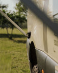 Detail view of Tactic Engineering magnetic awning support holding the Fiamma awning arm against the side panel of the Weinsberg X-Pedition 4x4 Sprinter by Ferrigato Camper