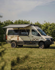 Weinsberg X-Pedition 4x4 Sprinter conversion by Ferrigato Camper with Fiamma awning extended, mounted to the van side using Tactic Engineering magnetic awning supports — no drilling, no permanent fixings