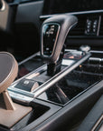 Tactic Engineering magnetic MagSafe phone mount installed in the storage pocket ahead of the gear selector in a Porsche Cayenne (2018-2023)