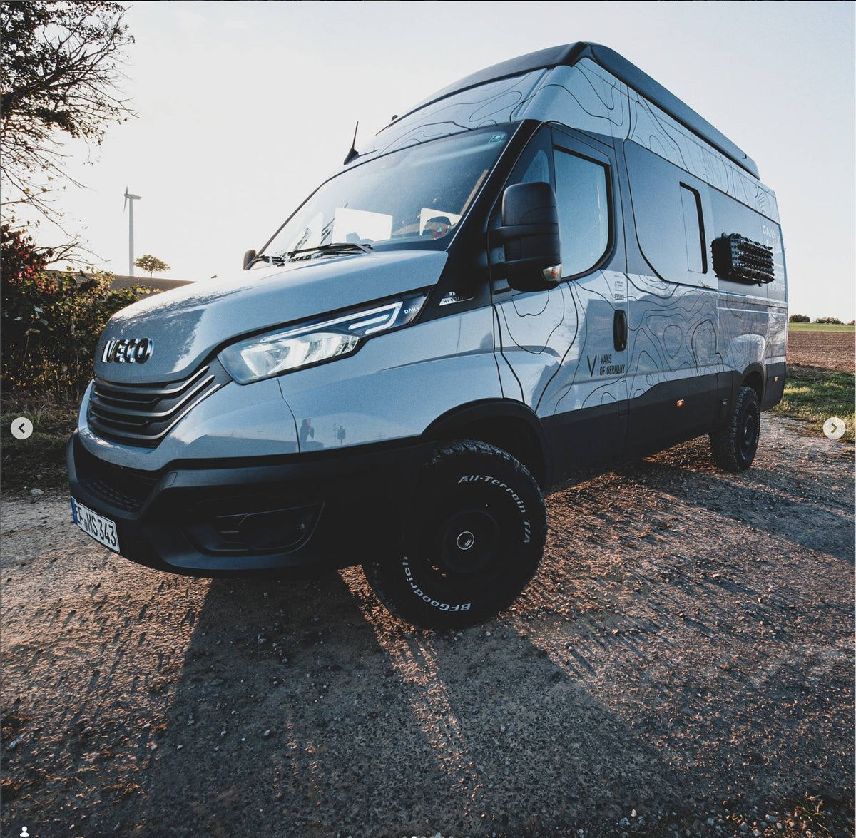 Iveco Daily 4x4 campervan on a gravel road with MaxTrax MK2 recovery boards on Tactic Engineering magnetic quick-release mounts