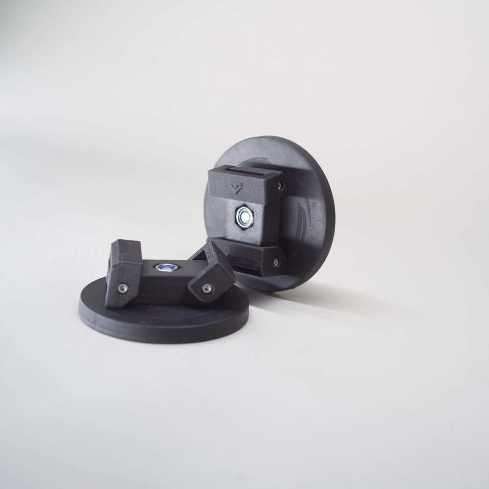 Pair of Tactic Engineering magnetic awning supports for Dometic awnings, SLS 3D printed nylon clamps with Tactic logo on rubber coated neodymium magnet bases, product photo on gray background showing both supports from different angles