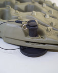 Close up of Tactic Engineering magnetic mount with stainless steel quick release pin and safety cable installed on olive green TRED GT recovery board, SLS 3D printed nylon mount on rubber coated neodymium magnet base visible underneath the board