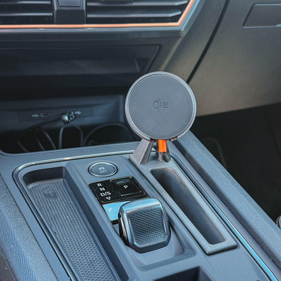MagSafe-compatible Qi2 wireless charging puck on Cupra Formentor console phone mount, push-fit install beside the gear selector