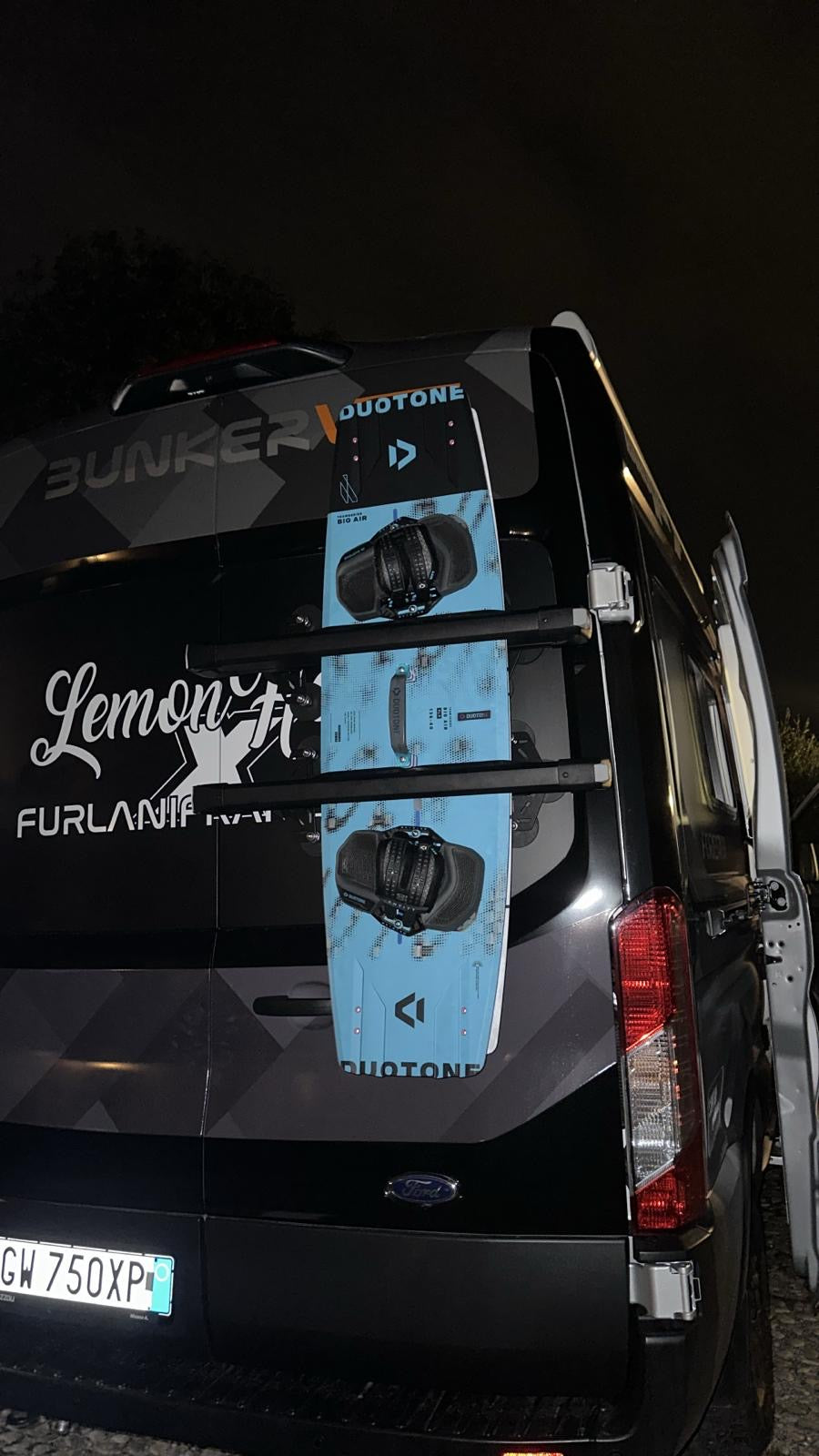 Back of a black vehicle with surfboards attached, featuring 'Bunker' and 'Lemon' branding. Showcasing the new Tactic Vans Ski/Snowboard and Kite Surf Mount for thule Snowpack.