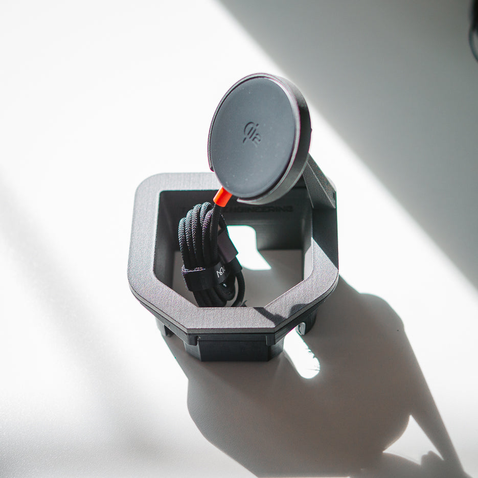 Tactic Engineering 2024 Toyota Land Cruiser 250 MagSafe phone mount — top view showing the Swiss-made SLS 3D-printed sintered nylon center console cupholder cradle with the included McDodo Qi2 MagSafe wireless charger and braided USB-C cable