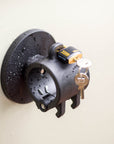 Tactic Engineering circular magnetic mount in black SLS 3D printed nylon with ABUS marine grade lock and key, water resistant design shown with rain droplets on surface