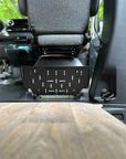 Tactic Engineering magnetic under seat organizer empty MOLLE panel view installed beneath Mercedes Sprinter 907 rear seat, black powder coated steel tray with MOLLE slots for modular gear attachment, no tools required magnetic installation on van floor