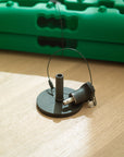 Tactic Engineering magnetic quick release mount for generic recovery boards, single unit showing rubber coated neodymium magnet base with stainless steel quick release pin and safety cable, green TRED recovery board in background