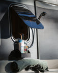 Tactic Engineering complete magnetic outdoor shower kit installed on van, showing magnetic shower head holder, shampoo holder with toiletries, and towel hook mounted on vehicle exterior