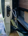 SafeNight door lock installed on Mercedes Sprinter 907 showing carabiner and padlock securing the sliding door latch mechanism