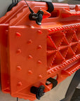 Orange Sumex recovery boards mounted on a white van side panel with a Tactic Engineering magnetic quick-release pin and safety cable