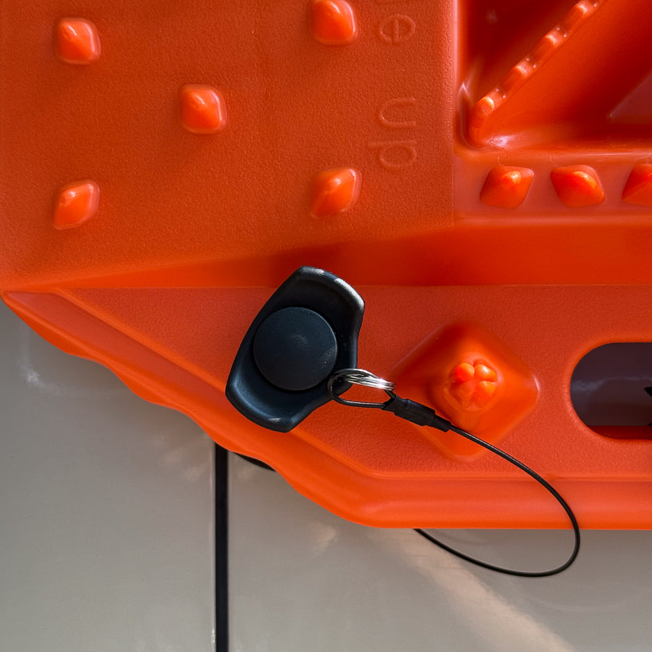 Two orange Sumex recovery boards mounted flat to a van side panel with Tactic Engineering magnetic quick-release supports