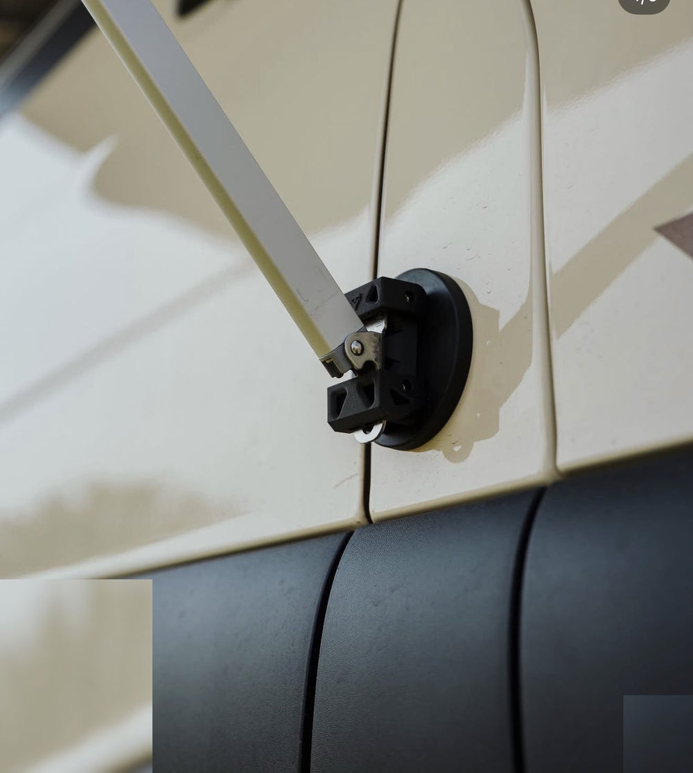 Close-up of Tactic Engineering magnetic awning mount with quick-release pin holding the awning arm on the Weinsberg X-Pedition 4x4 Sprinter by Ferrigato Camper