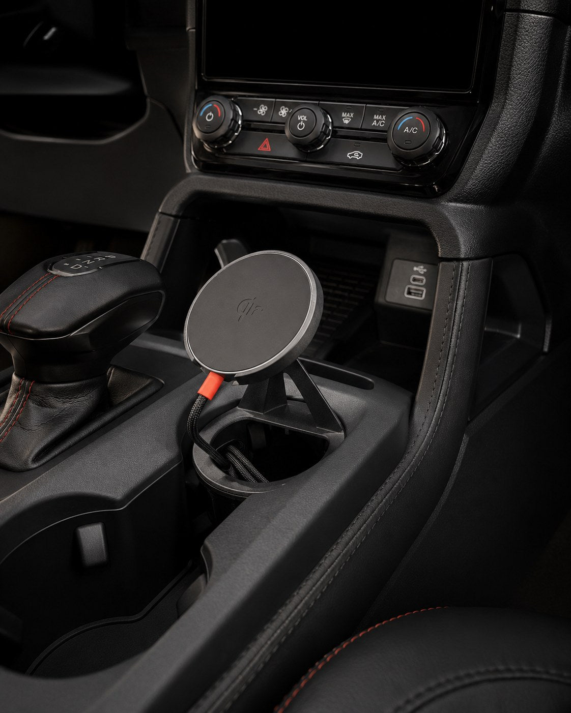 Tactic Qi2 MagSafe phone mount installed in a Ford Ranger 2024+ centre console cupholder, beside the gear selector