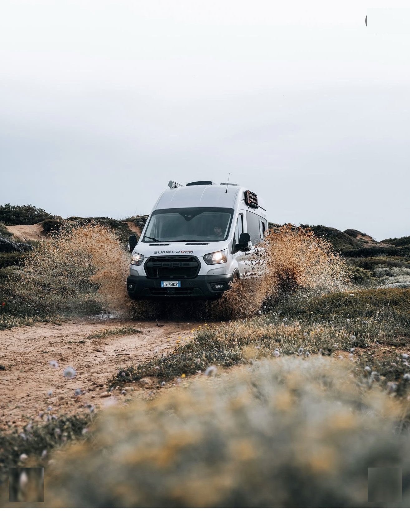 Francesco Furlani driving his Ford BunkerVan through Portuguese dune trails, equipped with Tactic Engineering magnetic mounts for TRED recovery boards