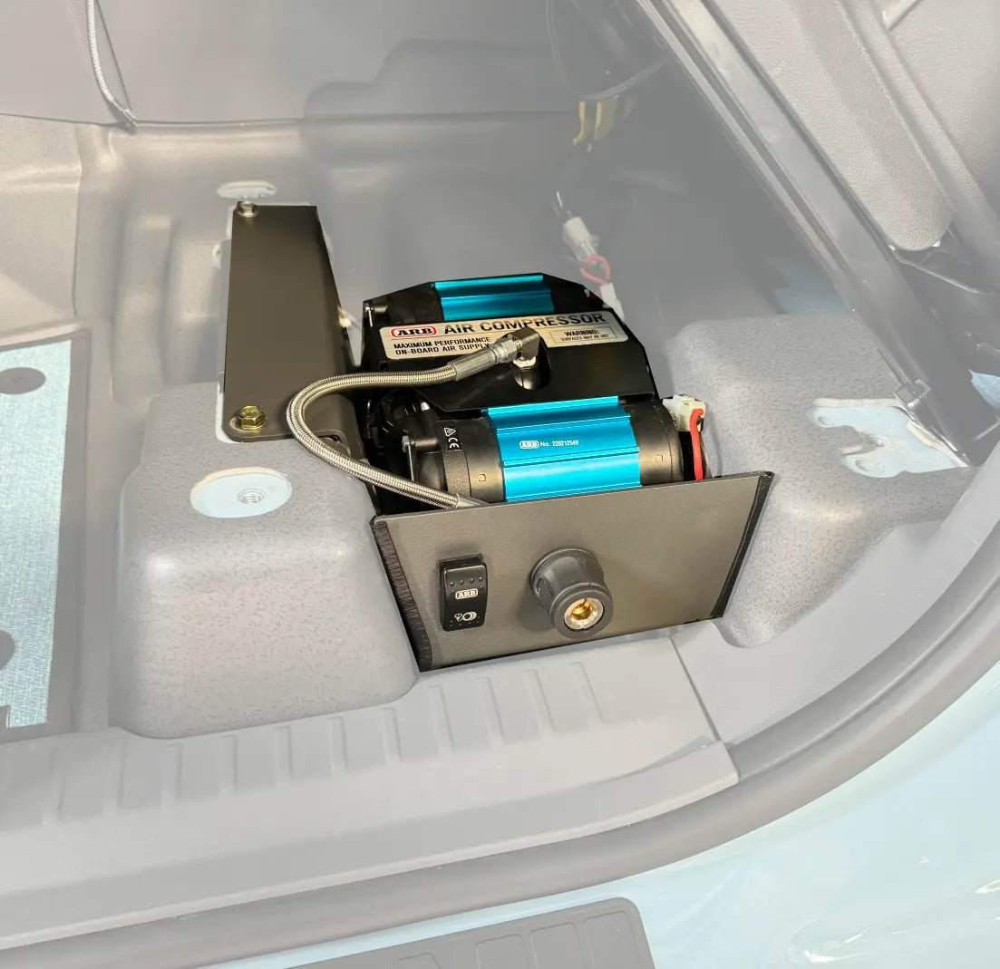 OWL underseat air compressor mount kit installed in INEOS Grenadier with ARB compressor and powder coated aluminum bracket