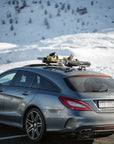 Mercedes-Benz CLS Shooting Brake in the Swiss Alps carrying skis on a Tactic Engineering magnetic roof mount, no roof bars fitted
