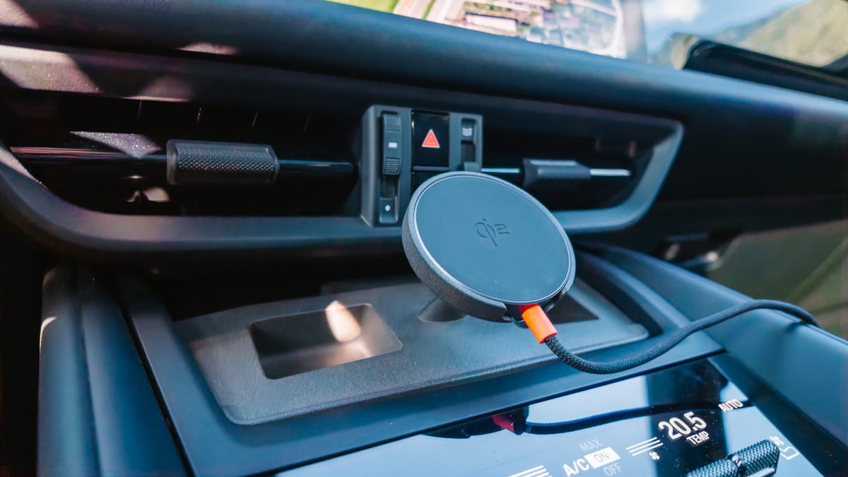Porsche Macan EV centre console with the Tactic Engineering MagSafe phone mount installed, Qi2 charger seated below the dashboard vents