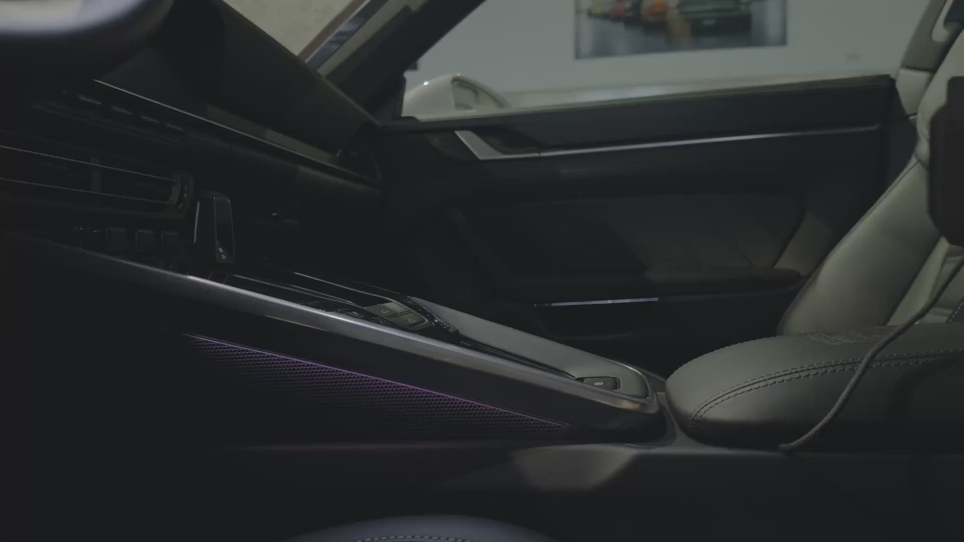 Installing the Tactic Engineering magnetic phone mount in a Porsche 911 (992). The mount sits in the centre-console storage bucket beside the gear selector, the phone attaches magnetically to the Qi2 charging head, and the screen stays upright and readable. No drilling. No adhesive. Made in Switzerland.