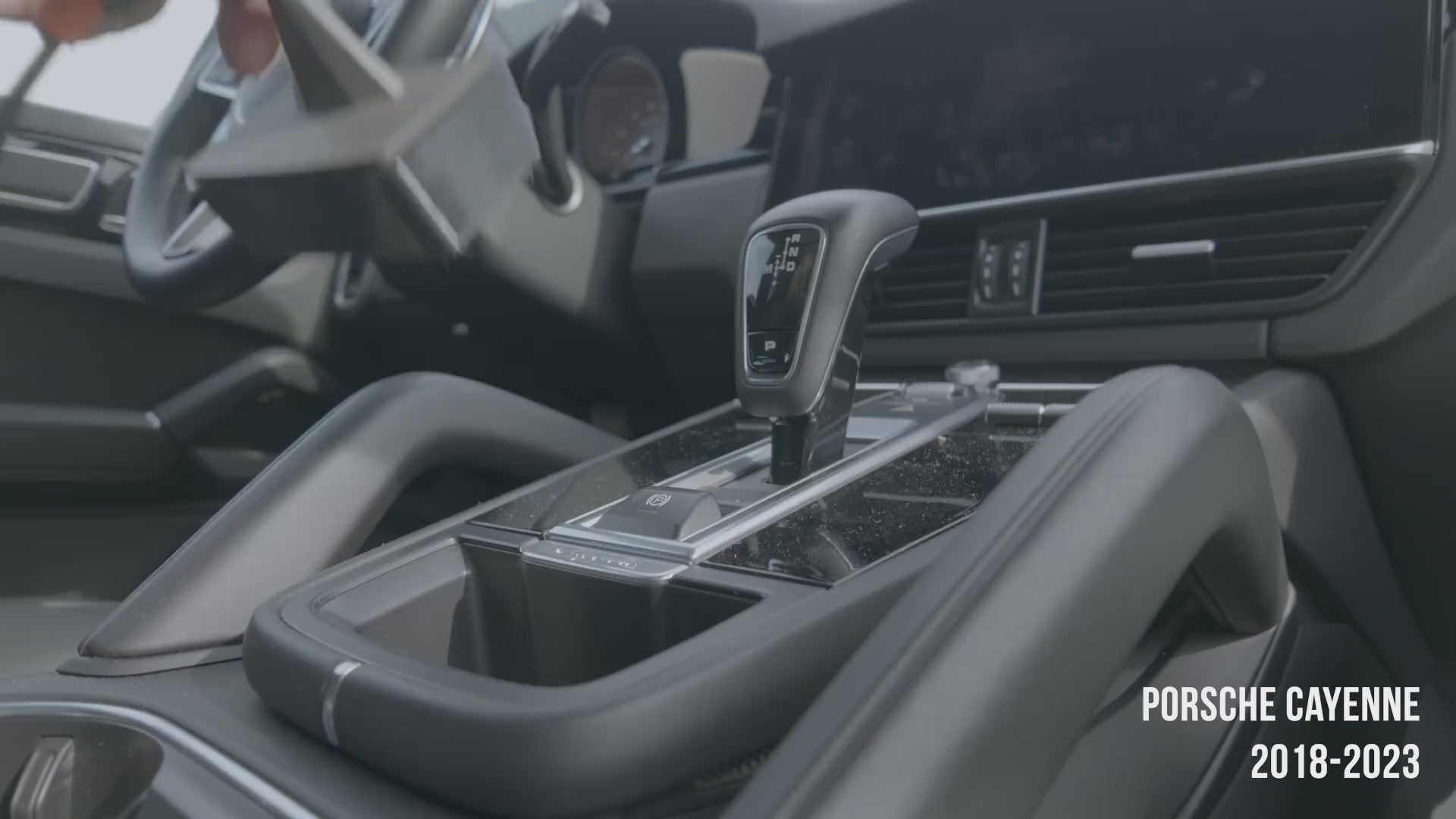 Porsche Cayenne 2018–2023 magnetic phone mount installation video — mount slots into the storage pocket ahead of the gear selector, no drilling, no adhesive. MagSafe charging head snaps on and the phone attaches magnetically. Tactic Engineering, Swiss made.