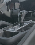 Porsche Cayenne 2018–2023 magnetic phone mount installation video — mount slots into the storage pocket ahead of the gear selector, no drilling, no adhesive. MagSafe charging head snaps on and the phone attaches magnetically. Tactic Engineering, Swiss made.