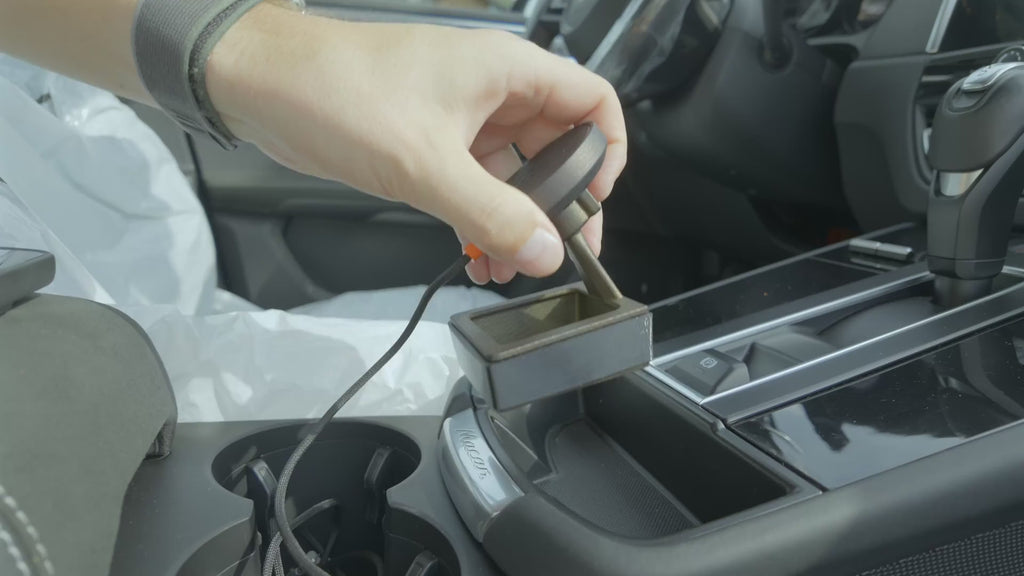 Installing the Tactic Engineering magnetic phone mount in the rubber-lined console cubby of a 2022-2026 Porsche Macan and snapping an iPhone onto the MagSafe Qi2 charger, no drilling, no tools