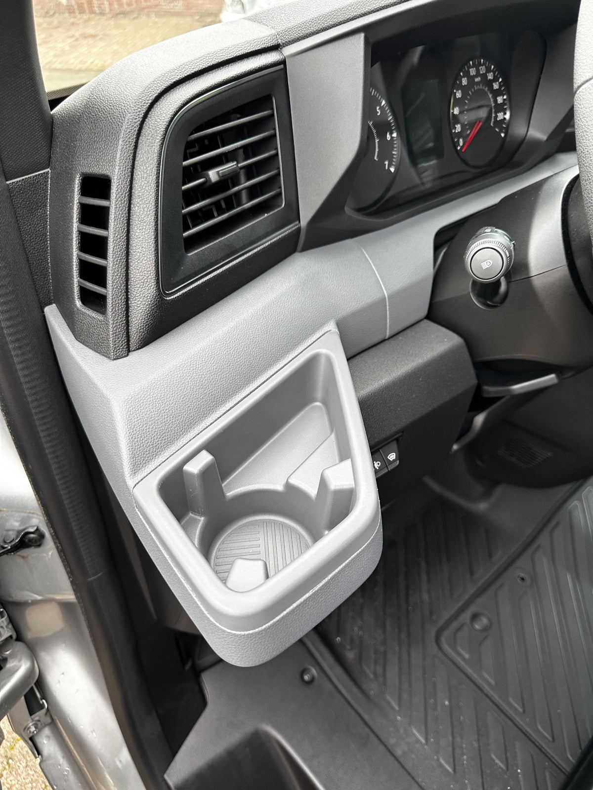 Renault Master 2024+ driver side dashboard: the moulded tray with cupholder where the Tactic Engineering phone mount sits. No drilling, no adhesive.