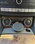 Tactic MagSafe phone holder installed in the center console cupholder of a Mercedes E-Class W212, with the McDodo Qi2 charger mounted below the climate controls.
